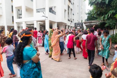 PUNE, MAHARASHTRA, INDIA - 8 EYLÜL 2022: Kimliği belirlenemeyen inançlı insanlar, su kaynaklarının yakınına dalmadan önce Hindu tanrısı Ganesha 'ya dua ediyorlar (Ganesh Chaturthi), yıllık festival