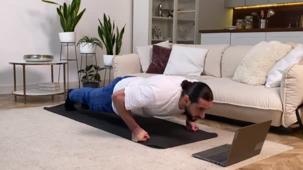 Mid Adult Man Doing Push Ups Exercise Video Tutorial Laptop — Stockvideo
