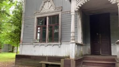 Old traditional wooden house with carved windows. Rundown house. Summer cottages of 19th century - suburb of Kyiv, Ukraine. August 1 2021.