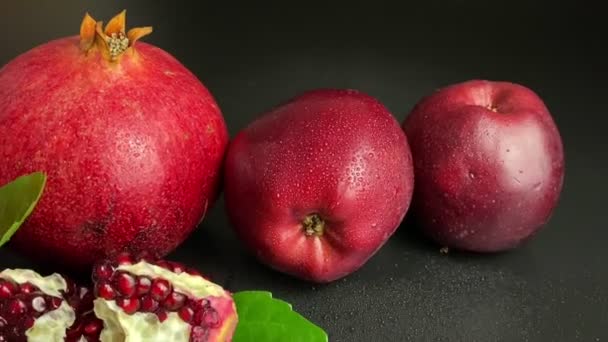 Composition Ripe Pomegranates Red Apples Green Leaves Black Background Segments — Stock Video