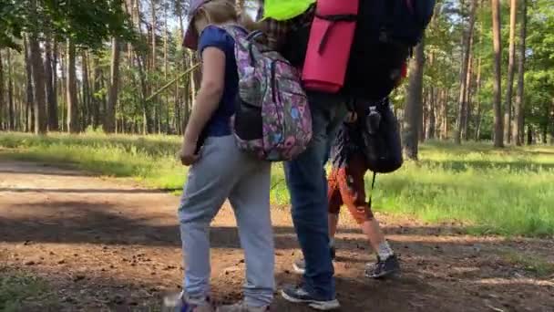 Rotating Shot Father Sibling Traverse Trail Carrying Backpacks Filled Gear — Video