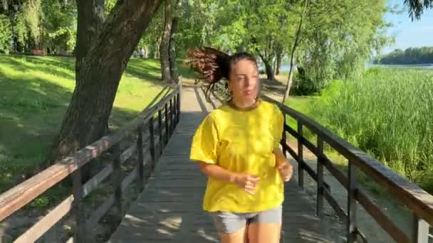 Front View Sporty Multiracial Young Woman Takes Refreshing Jog Scenic — Stock Video