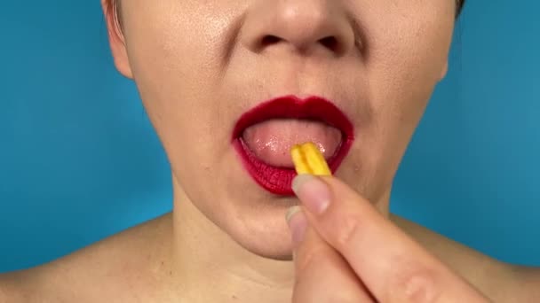 Unrecognizable Young Adult Woman Vibrantly Colored Lips Eats Food Delicious — Stock Video