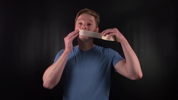 Portrait Handsome Young White Man Taping His Mouth Adhesive Tape — Stock Video