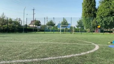 Odaklanmış genç bir bayan atlet dinamik bir şekilde ısınma egzersizleri yapıyor ve dışarıda esniyor. Spor giyim sektöründe bedenini düzenli bir rutin içinde fiziksel taleplere özenle hazırlar.