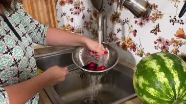 İçerideki sulu meyvelerin tadını çıkaran genç bir kadın taze ve sağlıklı tadını çıkarıyor. Rahatlamış ve memnun, sakin ve rahat bir atmosferde sağlıklı beslenmenin basit zevkini kucaklıyor..