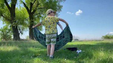 Küçük baba ve oğlu yaz pikniğinin tadını çıkarıyor, birlikte güzel vakit geçiriyorlar. Dışarıdaki eğlenceli aktivitelere katılıyorlar, sıcak güneşin altında mutlu anılar yaratıyorlar.