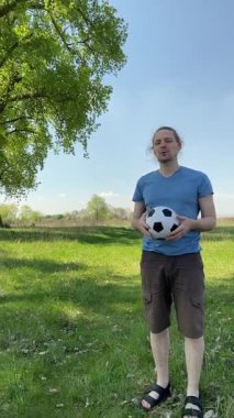 Genç bir baba ve oğlunun yaz pikniğini otlakta birlikte geçirdiği dikey görüntüler. Dışarıdaki eğlenceli aktivitelere katılıyorlar, sıcak güneşin altında mutlu anılar yaratıyorlar.