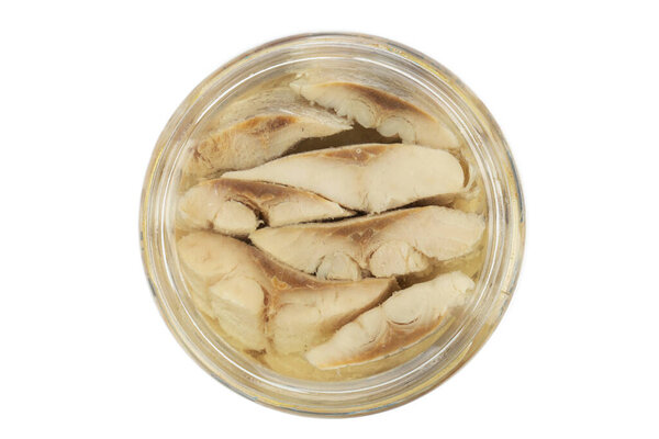 Sliced salted and pickled herring fish in jar isolated on white background. Salted fillet of herring. File contains clipping path.