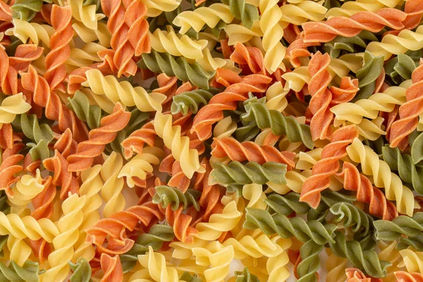 Raw Colored Pasta Fusilli Uncooked Pastas Background Top View — стоковое фото
