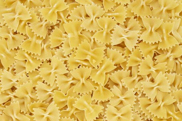 乾燥したイタリアのパスタマカロニ弓の質感が落ちる 閉めろ 背景炭水化物食品 — ストック写真