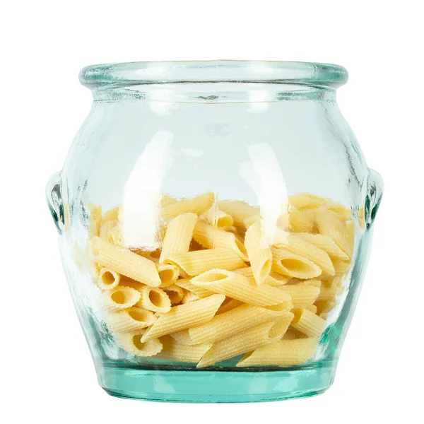 stock image Pennette rigate. Raw pasta in a glass jar for storing bulk products. isolated on white background. File contains clipping path.