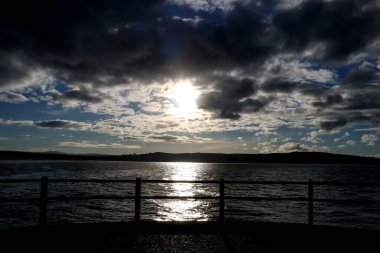 Sea view from harbour light jetty in Ayr Scotland at dusk