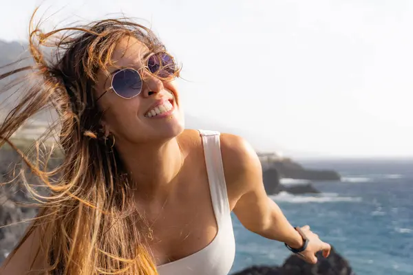 Woman Sunglasses Smiling Looking Camera Her Hair Blown Wind Viewpoint — Stock Photo, Image