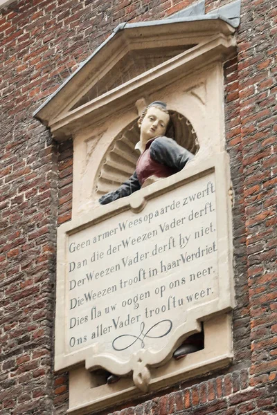 stock image Amsterdam, Netherlands. November 2022. Stone inscription at the former orphanage in Amsterdam. High quality photo