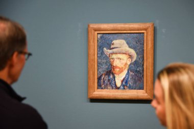 Amsterdam, Netherlands. January 2023. Visitors admiring a self portrait of Vincent van Gogh. High quality photo