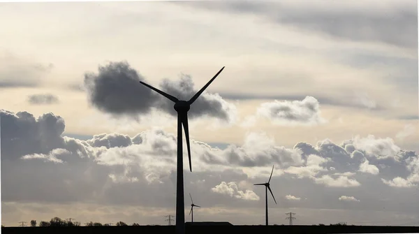Breezand, Netherlands. January 2023. Silhouette of wind turbine against a storm sky. High quality photo