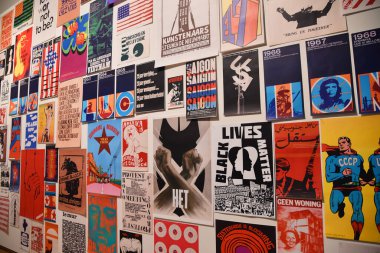 Amsterdam, Netherlands. January 2023. Visitor takes photo of a wall with protest posters in Amsterdam. High quality photo