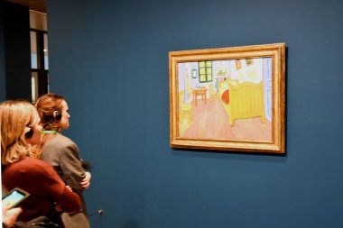 Amsterdam, Netherlands. January 2023. Visitors admire paintings by Vincent van Gogh in Amsterdam. High quality photo