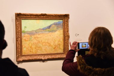 Amsterdam, Netherlands. January 2023. Visitors admire paintings by Vincent van Gogh in Amsterdam. High quality photo