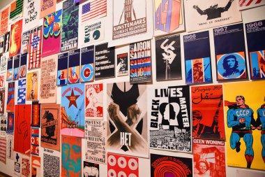 Amsterdam, Netherlands. January 2023. Visitor takes photo of a wall with protest posters in Amsterdam. High quality photo