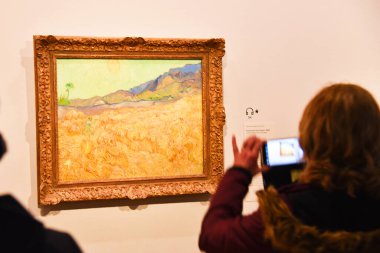 Amsterdam, Netherlands. January 2023. Visitors admire paintings by Vincent van Gogh in Amsterdam. High quality photo