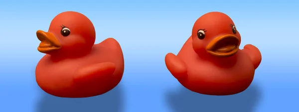 Red rubber ducks isolated on light blue background
