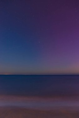 May 11, 2024, the phenomenon of the Northern Lights visible when observing the sky in Tuscany. Aurora borealis reflected in the sea. San Vincenzo, Tuscany, Italy clipart