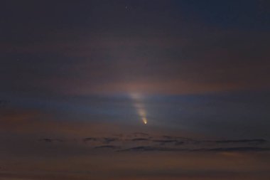 C/2023 A3 (Tsuchinshan ATLAS), a comet from the Oort cloud, imaged at sunset in the clouds on October 13, 2024 clipart