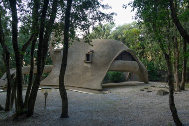 Casa Dinosauro, contemporary zoomorphic architecture in Tuscany, designed by architect Vittorio Giorgini. Baratti, Piombino, Italy clipart