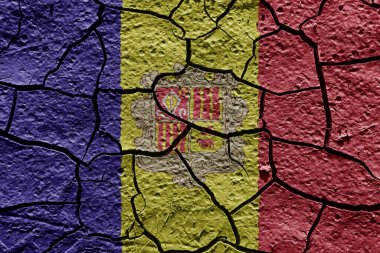Andorra flag on a mud texture of dry crack on the ground