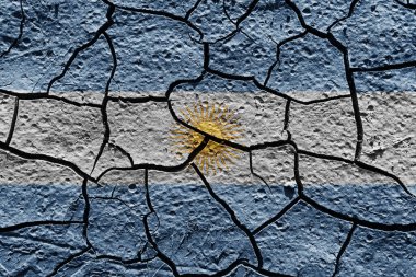 Argentina flag on a mud texture of dry crack on the ground