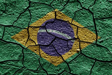 Brasil flag on a mud texture of dry crack on the ground