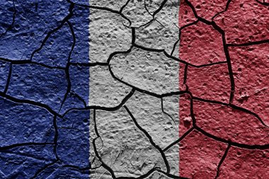 France flag on a mud texture of dry crack on the ground