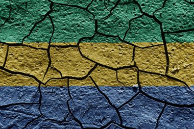 Gabon flag on a mud texture of dry crack on the ground