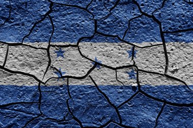 Honduras flag on a mud texture of dry crack on the ground