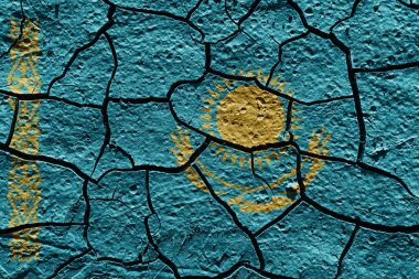 Kazakhstan flag on a mud texture of dry crack on the ground