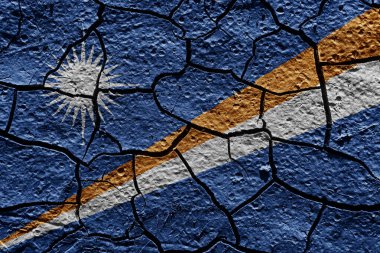 Marshall Islands flag on a mud texture of dry crack on the ground