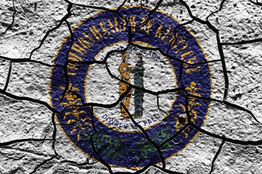 Kentucky state Seal flag of United States on a mud texture of dry crack on the ground