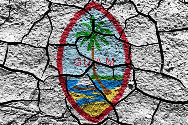 Guam state Seal flag of United States on a mud texture of dry crack on the ground