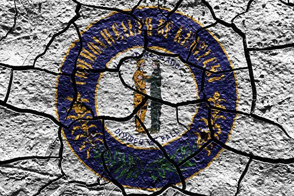 Kentucky state Seal flag of United States on a mud texture of dry crack on the ground
