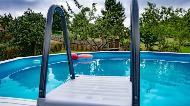 ball floating in a blue garden pool at a time when everything is quiet