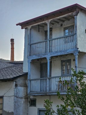 Ahşap balkonlu iki katlı ev terk edilmiş ve arka planda şömine var.