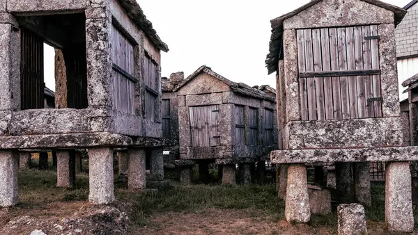 stock image group of stone and wood constructions dedicated to the storage of the harvest in an elevated and airy place for conservation