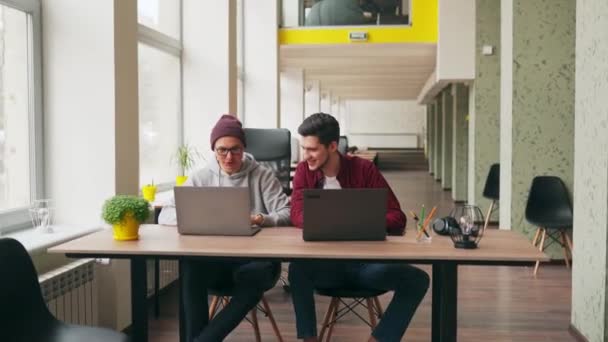 Dva Hipsteroví Spolupracovníci Sdílející Nápady Projektové Sezení Notebooky Prostorné Kanceláři — Stock video