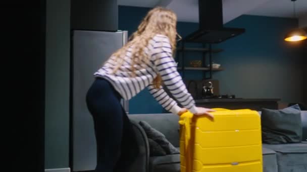 Woman Drags Her Wheeled Suitcase Hotel Check Falls Sofa Rest — Stock Video