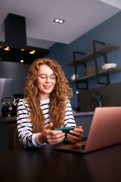 Pretty Blonde Woman Distracted Work Laptop Watching Video Smartphone Freelancer — Stock Photo, Image