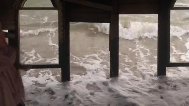 古董店的女服务员在沙滩上的潮水中沉没 站在被风浪冲刷过的旧木结构中的妇女被洪水淹没了 梦幻般的超现实电影镜头 — 图库视频影像