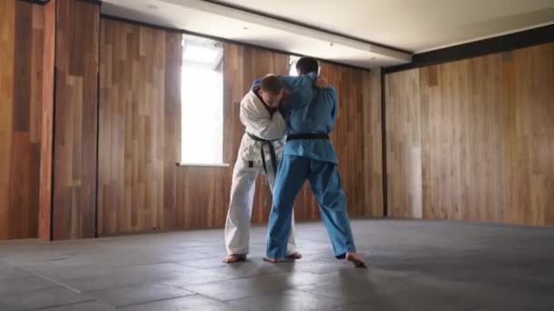 Martial Arts Men Kimonos Practice Kicks Punches Male Fighters Wearing — Vídeo de stock