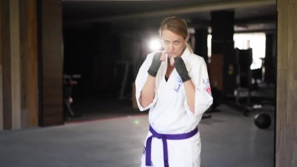 Portrait Sportswoman Kimono Facing Camera Moving Aggressively Ready Fight Female — Stock Video
